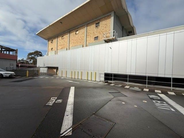 Wide view of the ALPOLIC™ façade upgrade beneath the existing brick building