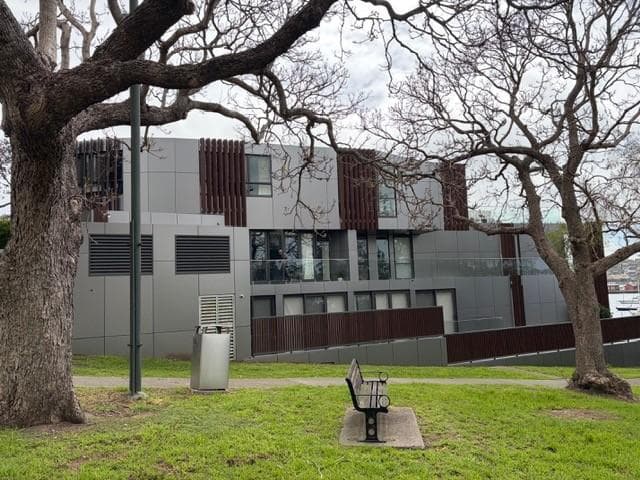 Breeze Apartments façade recladding with ALPOLIC™ NC/A1 panels viewed across parkland in Drummoyne