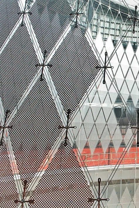 Perforated aluminium daylight reflecting panels suspended within Fulton Center skylight