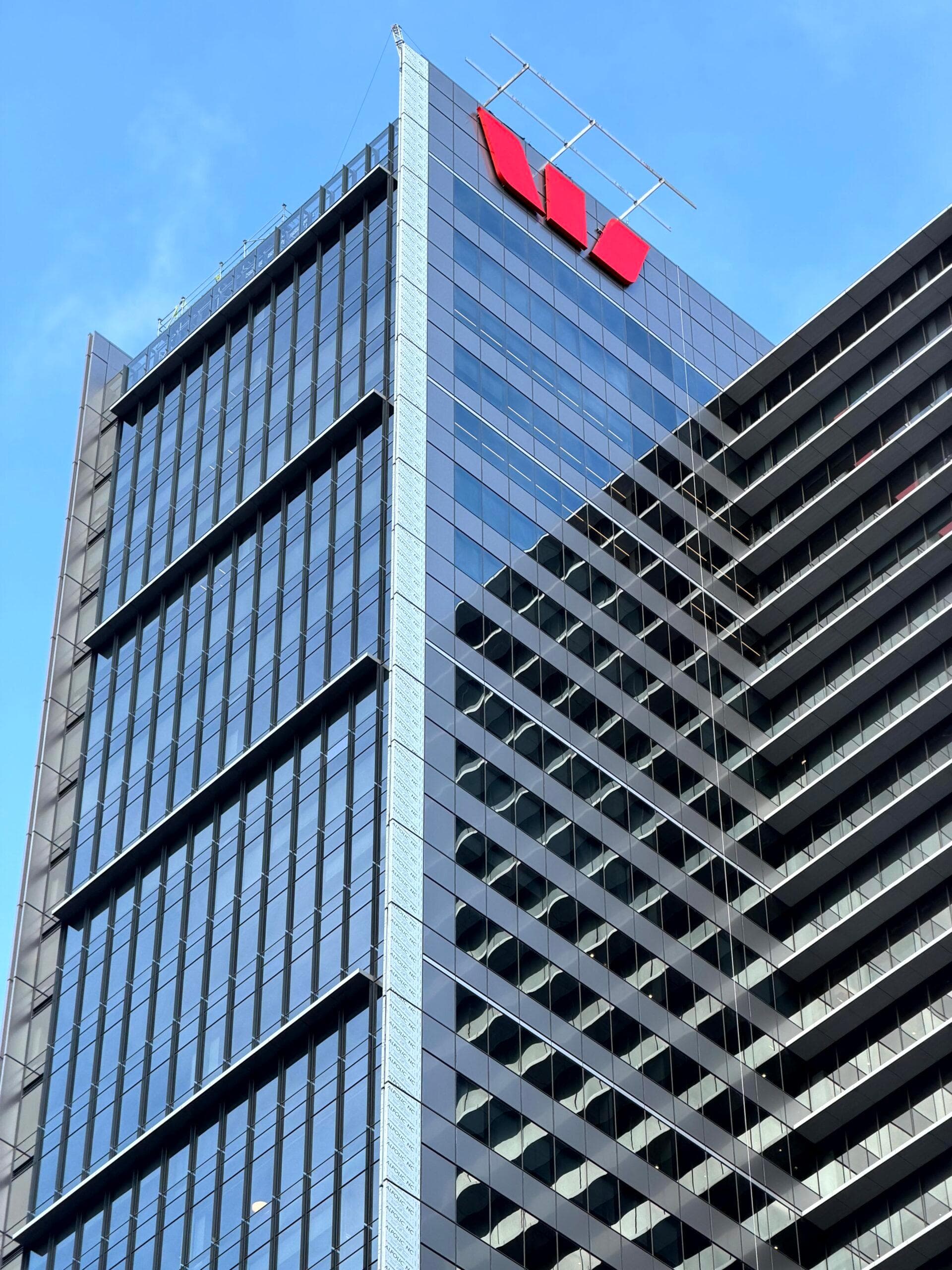 Upper façade of Westpac Place with dark ALPOLIC™ panels and rooftop logo