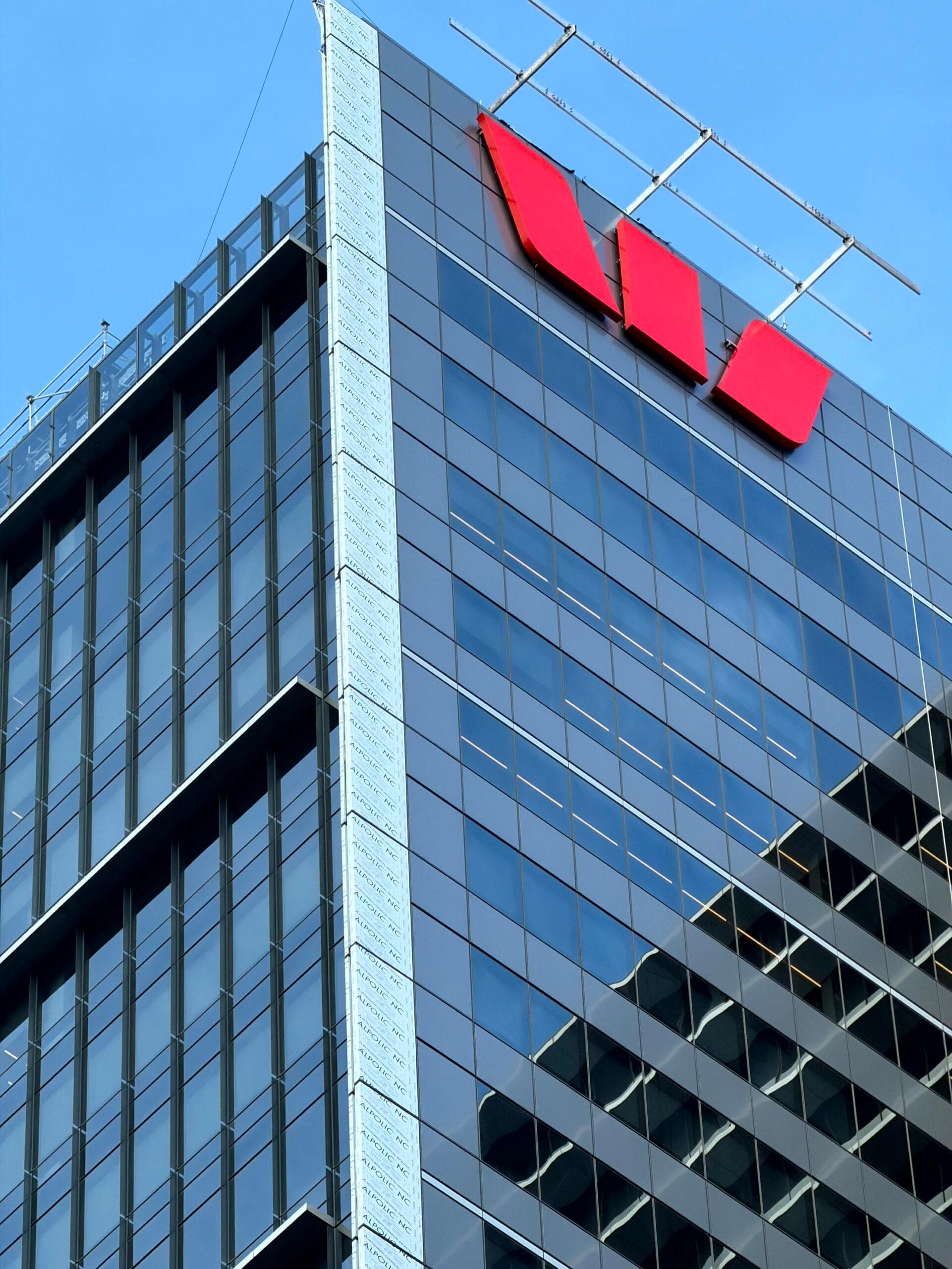 Close-up of the Westpac Place corner façade with ALPOLIC™ panels and rooftop logo