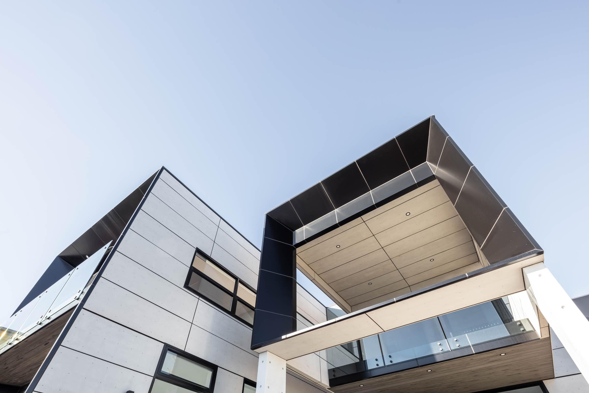 Upward architectural view showing black ALPOLIC™/fr cladding detail and geometric soffit design