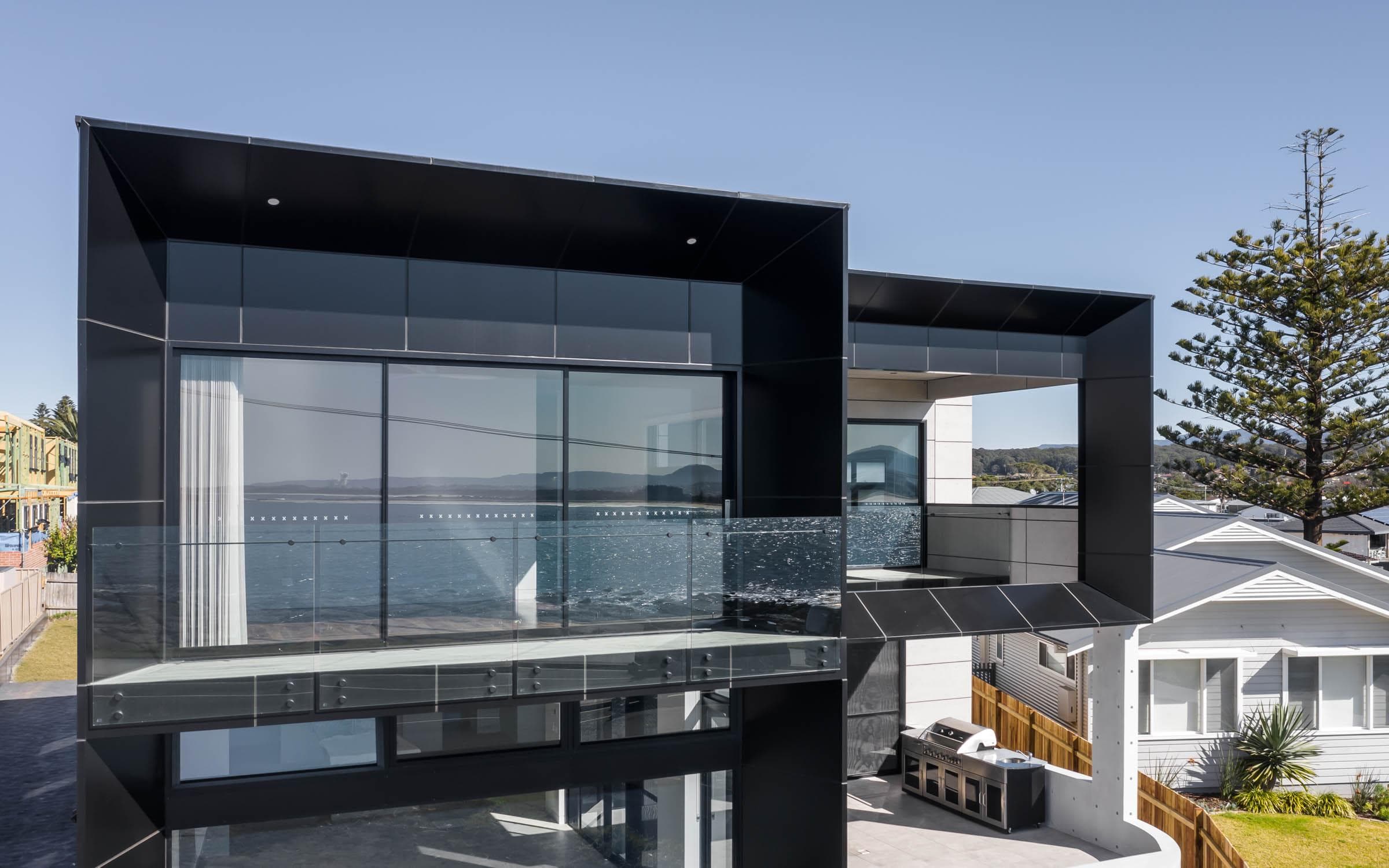 Upper-level balcony detail with ALPOLIC™/fr cladding framing sea views at Barrack Point